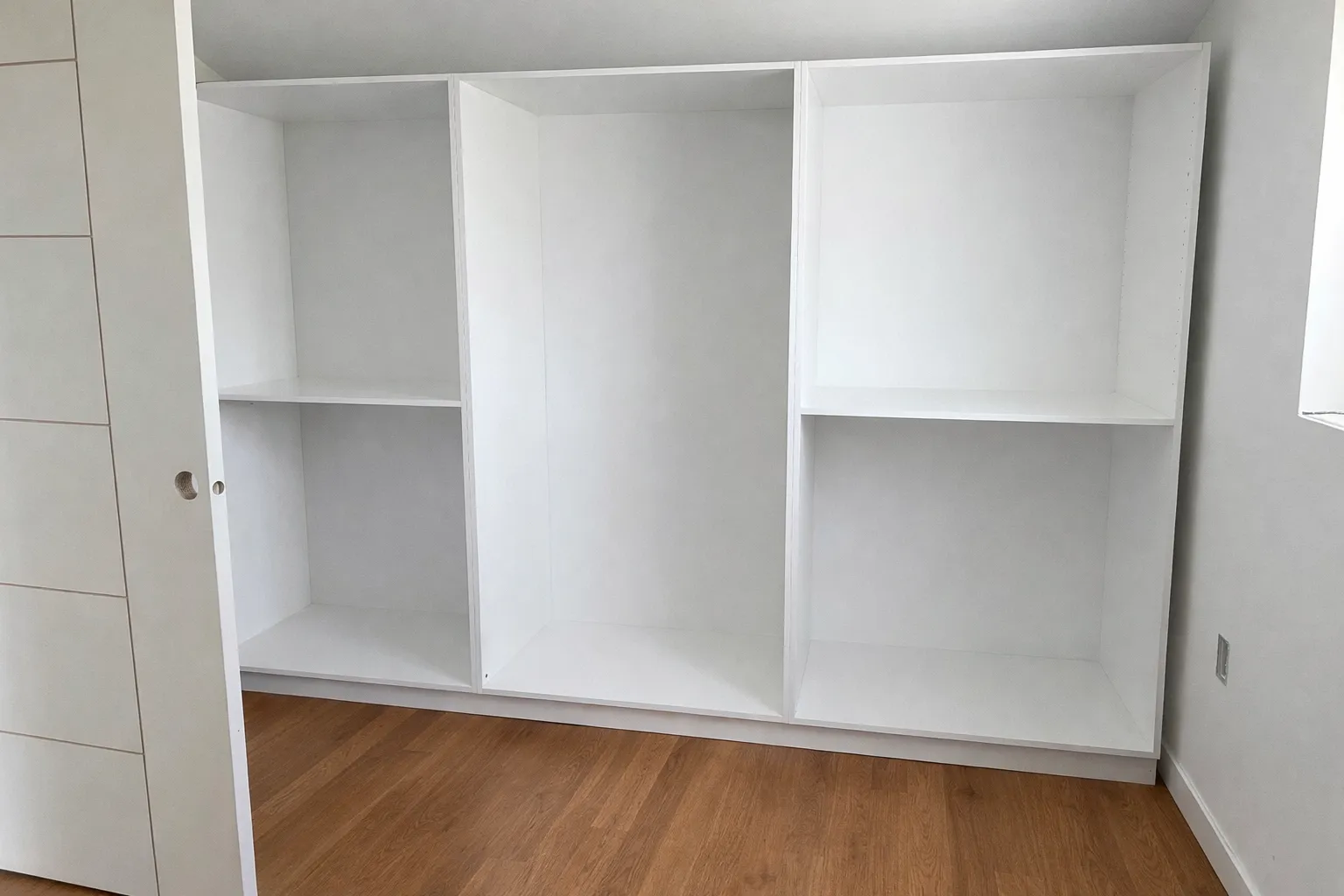 White built-in closet system with shelving and drawers