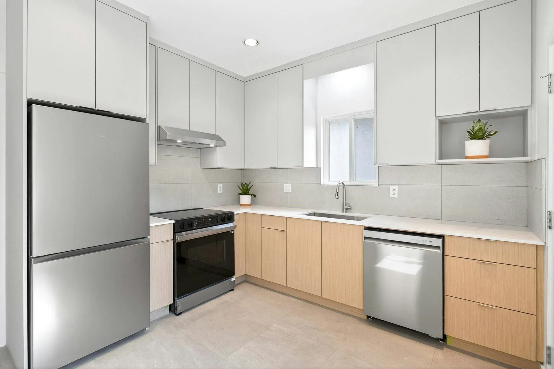 Custom cabinetry workshop and finished kitchen by Juniper Cabinetry